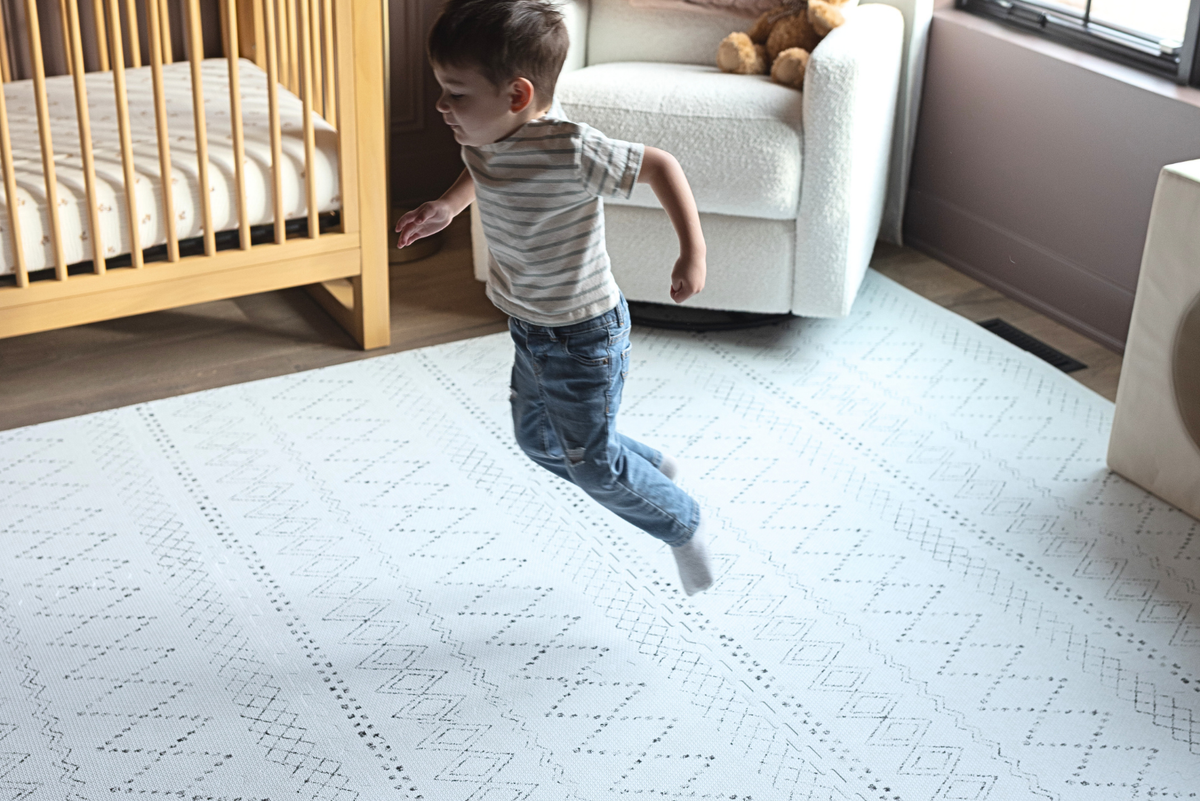 Child playing on a Little Landings designer foam play mat